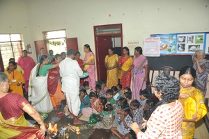 Members and staff blessing the children
